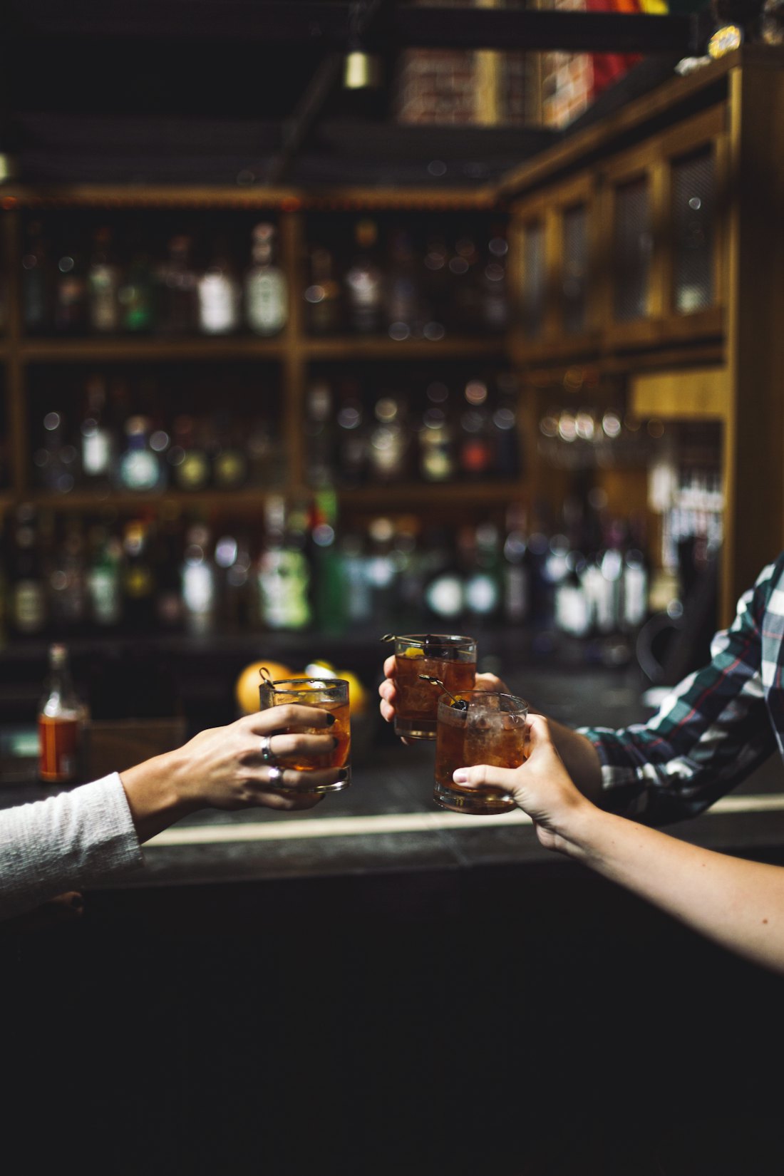 Two drinks meeting over a bar
